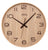Horloge murale avec boîtier en bois clair, chiffres et aiguilles noirs, et inscription AMS