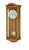 Horloge murale couleur bois avec cadran rond et pendule visible