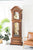 Enfilade en bois marron avec façade gaufrée, fenêtre en verre et poids visibles.