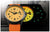 Vue montre homme : cadran jaune avec bracelet orange, montre noire partiellement visible