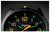 Vue de face d'une montre homme : cadran noir, index luminescents verts et jaunes, accent orange sur le logo