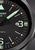 Détail de montre homme : cadran noir avec index luminescents et affichage de la date « 83 »