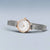 Bering Damenuhr mit roségoldener Einfassung, weißem Zifferblatt und Milanaise-Armband