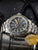 Bracelet de montre pour homme Traser avec lunette argentée et cadran sombre, index jaune et bleu
