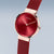 Bering Montre femme avec lunette or rose, cadran rouge et bracelet milanais rouge