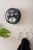 Horloge murale noire sur le mur avec chiffres rabattables et cadran analogique 2024