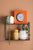 Horloge murale Karlsson au mur avec un cadre orange et un cadran blanc