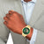 Herrenarmbanduhr Tommy Hilfiger mit goldfarbenem Edelstahlarmband und grünem Skelett-Zifferblatt