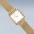 Bering Damenuhr mit goldfarbenem eckigem Gehäuse und Milanaise-Armband, weißes Zifferblatt