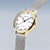 Montre femme boîtier rond doré avec bracelet milanais argenté et cadran blanc
