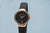 Damenarmbanduhr Bering mit schwarzem Zifferblatt und Milanaise-Armband in Roségold