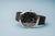Herrenarmbanduhr mit schwarzem Zifferblatt, Edelstahlgehäuse und Milanaise-Armband