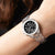 Montre pour femme au poignet avec cadran noir et bracelet en acier inoxydable