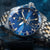 Vostok Europe Herrenuhr: blaues Zifferblatt, goldene Zeiger, GMT-Lünette und Edelstahlband