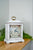 Horloge de table blanche avec cadran floral et dragonne dorée