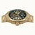Goldfarbene Herrenuhr von vorn, sichtbares Uhrwerk und leuchtend blaue Lünette