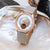 Damenuhr mit hellgrauem Lederarmband, roségoldenem Gehäuse und Mondphasenanzeige