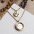Collier plaqué or avec grand pendentif cercle en nacre et pendentif motif rond