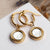 Boucles d'oreilles pendantes dorées : créoles avec deux pendentifs ronds et insert blanc