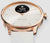 Montre connectée avec lunette or rose et bracelet beige, bouton latéral visible, cadran blanc.