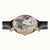 Herrenuhr mit schwarzem Lederband, roségoldener Lünette und offenem Automatik-Design