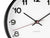 Gros plan : cadran d'horloge murale avec aiguilles noires et trotteuse rouge au centre