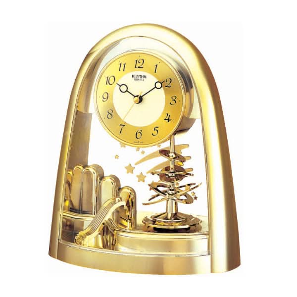 Horloge de table dorée avec cadran rond et balancier visible