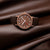Montre unisexe Mondaine avec bracelet en cuir marron ; boîtier rond et cadran marron avec aiguilles.