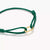 Bracelet textile vert, détail avec fermoir à œillets dorés