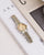 Mockberg Royal Armbanduhr mit bicolor Metallband und champagnerfarbenem Zifferblatt.