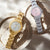 Zwei Damenuhren mit Metallarmband: silber mit rosa Zifferblatt, gold mit hellem Zifferblatt