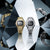 Casio G-Shock Herrenuhren, eine goldfarbene und eine silberfarbene Ausführung, nebeneinander