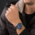 Herren-Armbanduhr mit schwarzem Zifferblatt und schwarzem Lederarmband am Handgelenk