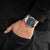 Herren-Armbanduhr am Handgelenk mit schwarzem Band und dunklem Zifferblatt