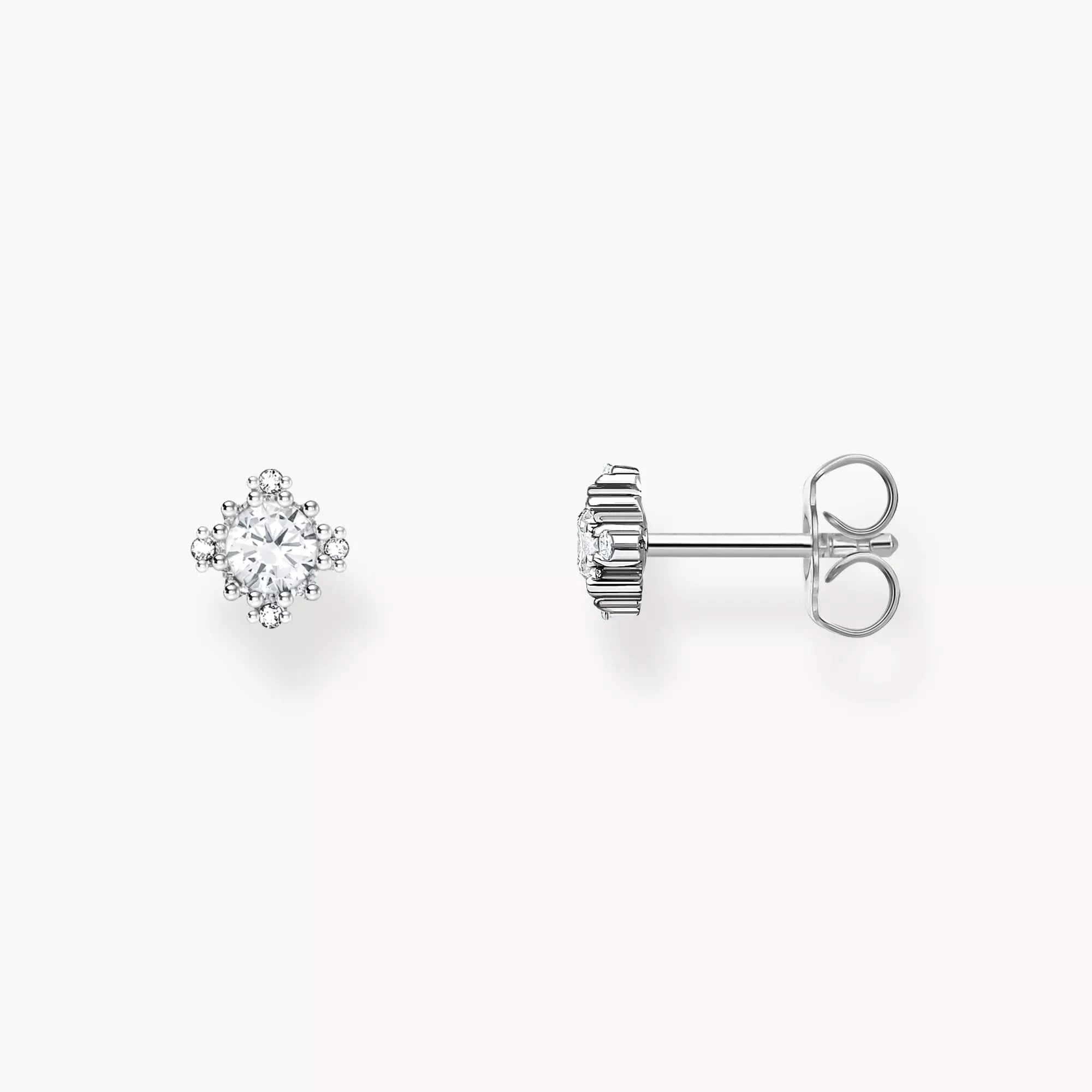 Paire de clous d'oreilles style vintage avec pierre claire dans un cadre argenté