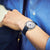 Seiko Presage Herrenuhr am Handgelenk, blaues Lederarmband und weißes Zifferblatt