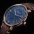 Montre homme avec cadran bleu, boîtier doré et bracelet en cuir marron