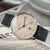 Montre homme avec cadran beige, bracelet en cuir noir et boîtier argenté