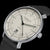 Montre homme avec cadran beige, accents verts et bracelet en cuir noir