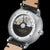 Montre homme avec mouvement visible dans le fond en verre et bracelet en cuir beige
