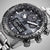 Montre homme gros plan : cadran noir avec compteurs chronographes et éléments lumineux