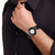 Mondaine Herrenuhr am Handgelenk mit schwarzem Lederarmband und Solar-Dial