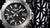 Detailansicht der Herrenuhr: schwarzes Zifferblatt, MR-G-Aufdruck und Zeiger