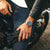 Edelstahl-Herrenarmbanduhr am Handgelenk mit blauem Zifferblatt, seitliche Ansicht der Gehäuseform