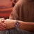 Citizen Automatik-Uhr am Handgelenk mit burgunder Zifferblatt und silber/goldfarbenem Band