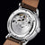 Montre homme avec fond transparent : mouvement mécanique dans un boîtier en acier inoxydable, bracelet en cuir marron