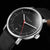 Montre automatique unisexe avec cadran noir et accents rouges, bracelet en cuir noir
