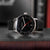 Montre automatique unisexe avec bracelet en cuir noir, cadran noir et aiguille des secondes rouge