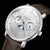 Vue rapprochée d'une montre Sternglas pour homme : cadran argenté avec phase lunaire bleue, bracelet en cuir marron.