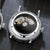 Fond de la montre bracelet pour homme avec mouvement automatique visible dans le fond du boîtier rond